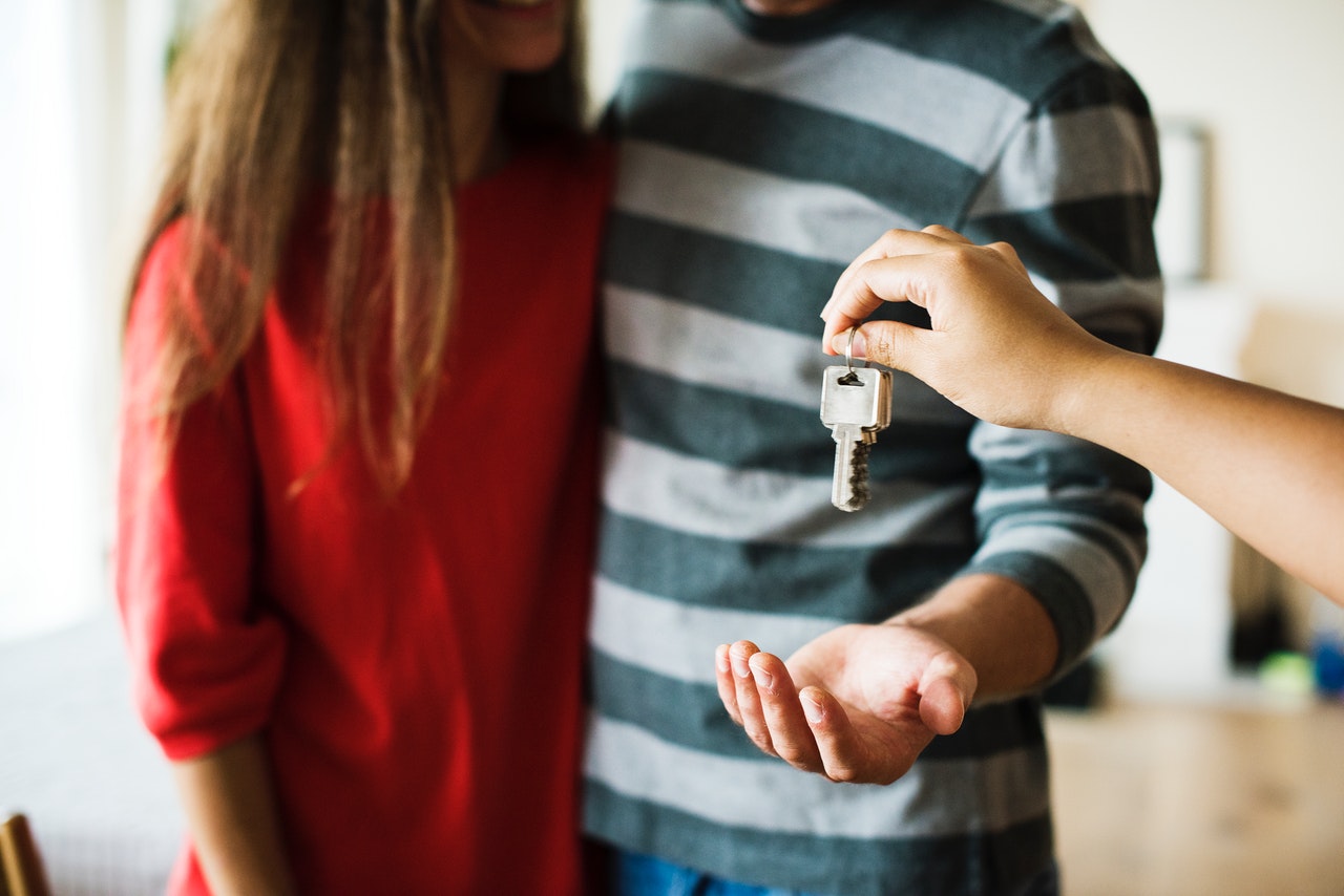 Person giving keys to a couple